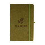 A green cork notebook with a matching elastic band and a logo featuring tea leaves.