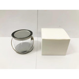 A medium clear PVC bucket with a metal handle next to a plain white box.