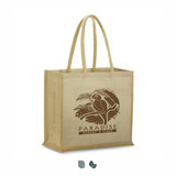 A tan juco tote bag with two sturdy handles and a logo featuring a parrot and tropical elements.