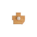 A custom-shaped bamboo lapel pin in a light brown colour, featuring a logo on the back.
