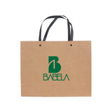 A medium brown paper bag with a knitted black handle and a logo on the front.