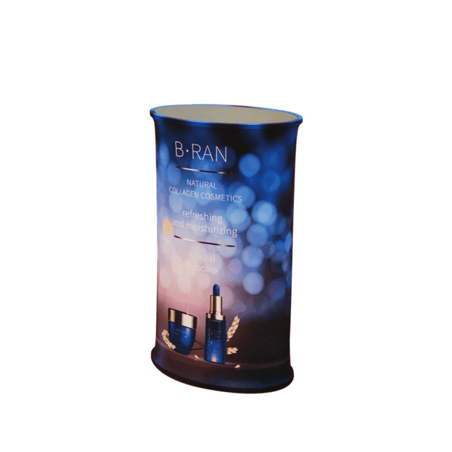 An oval pop-up booth featuring a gradient of blue hues and a logo, showcasing skincare products and branding.