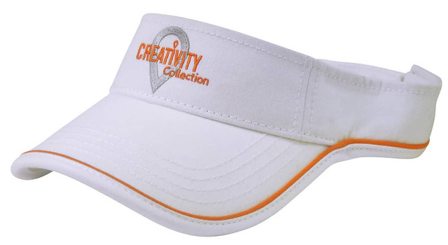 A white sports visor with orange detailing and a logo on the front.