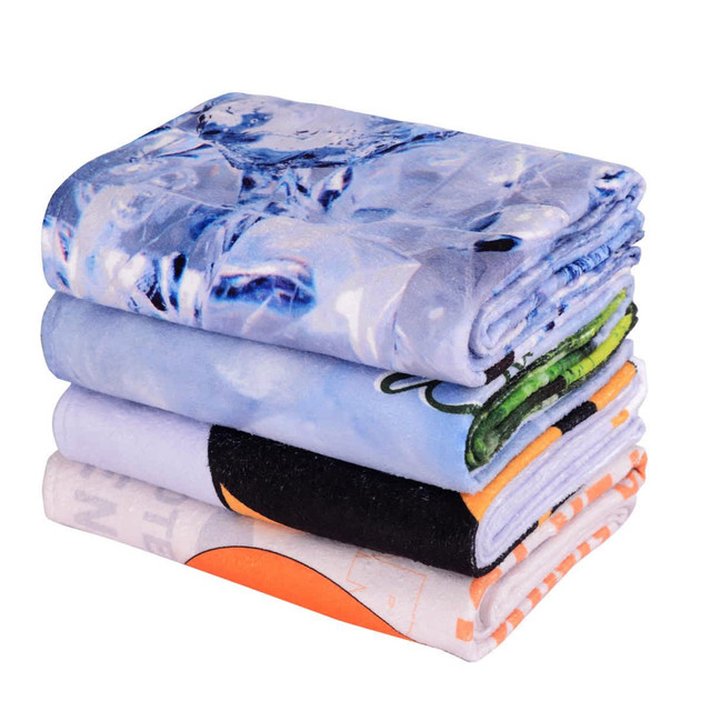 A stack of four gym towels in various colours, featuring designs including ice, abstract patterns, and solid hues.
