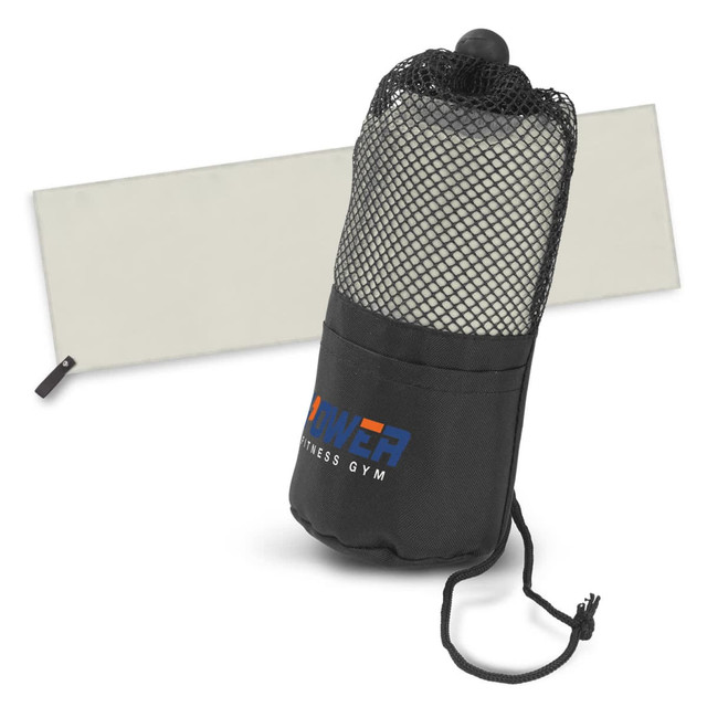 A black gym towel in a mesh pouch, featuring a branding logo, with a light grey background.