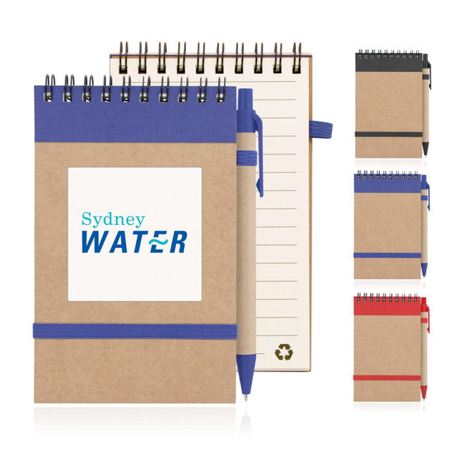 A recycled paper spiral-bound notepad in brown with blue, black, and red options, featuring a pen and an elastic band.
