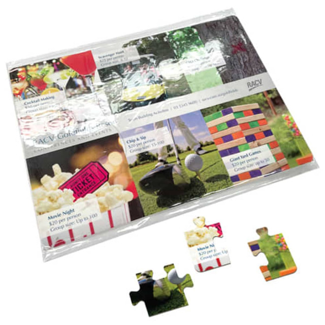 A4 Cardboard jigsaw featuring colourful images of drinks, games, and snacks, with pieces scattered on a surface.