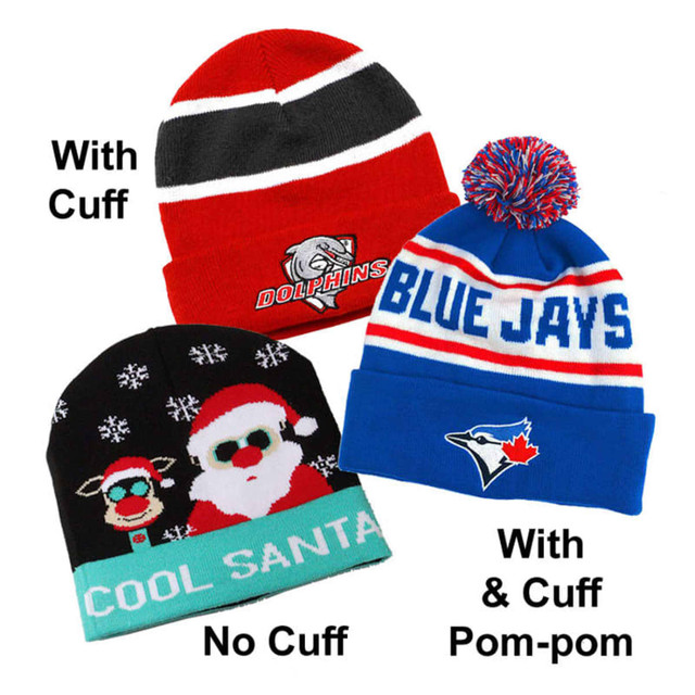 Three custom knitted beanies in red, black, and blue. One features a pom-pom and two have different cuff styles.