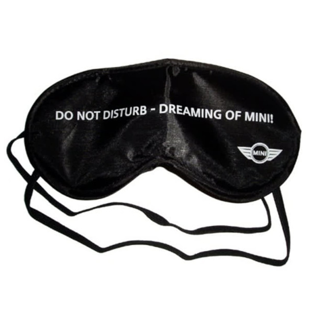 A black eye mask with a strap, featuring text and a logo on the front.