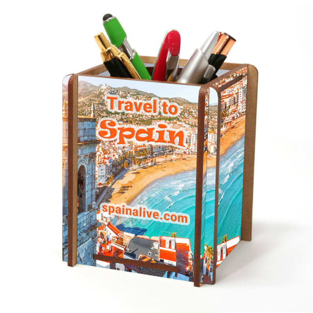 A full-colour pen caddy featuring various pens and pencils, with a vibrant image of a beach scene. The caddy has a logo.