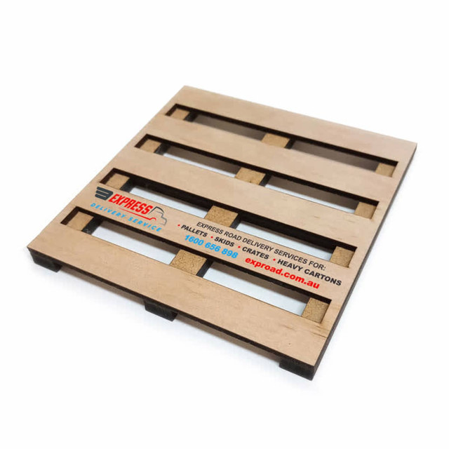 A wooden coaster designed to resemble a pallet, featuring a logo and a light brown finish.