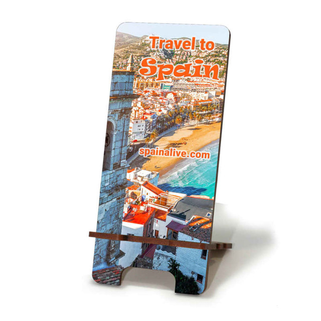 A full-colour eco MDF phone holder featuring a scenic view of a beach in Spain. It has a logo on the front.