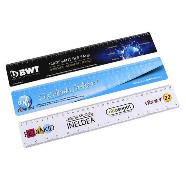 A set of four flexi rulers in black, white, and blue, featuring various logos and branding on each ruler.