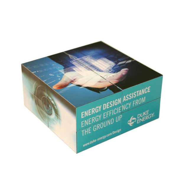 A promotional cube featuring a digital design, predominantly in teal, with a logo and graphical elements.