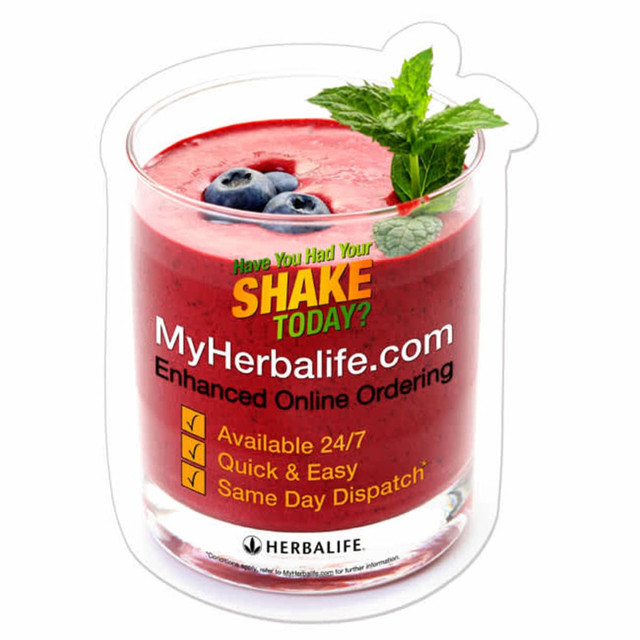 A custom-shaped gripper mat featuring a drink glass filled with a red smoothie, topped with mint leaves and blueberries.