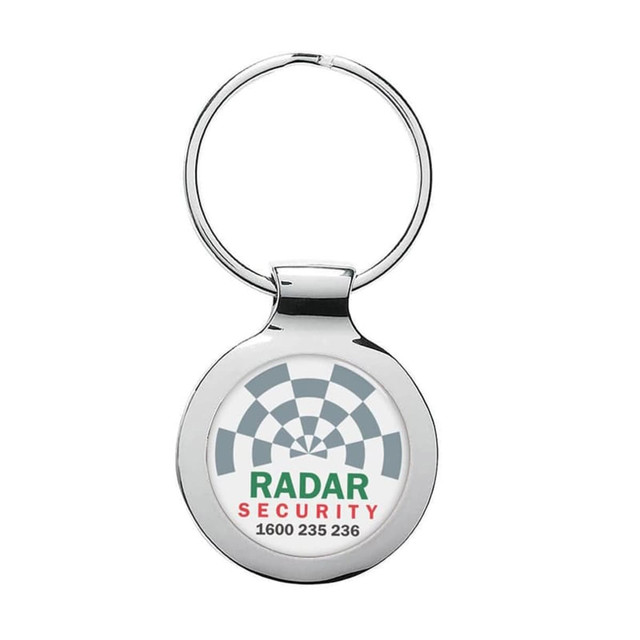 A silver metal keyring with a circular design and an embedded logo.