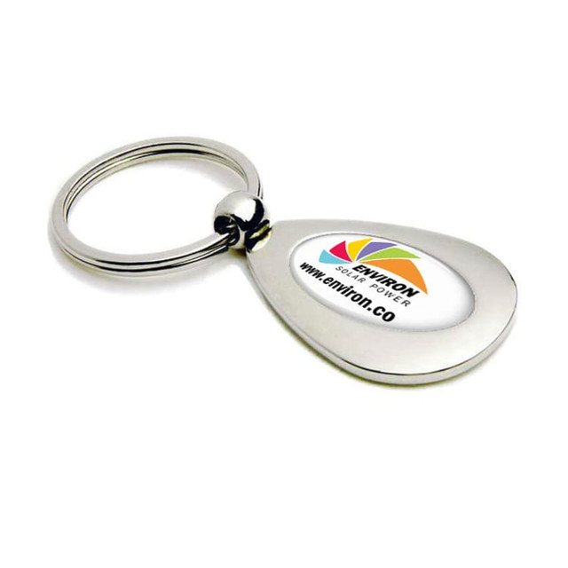 A silver metal keyring in a teardrop shape, featuring a logo on a white background.