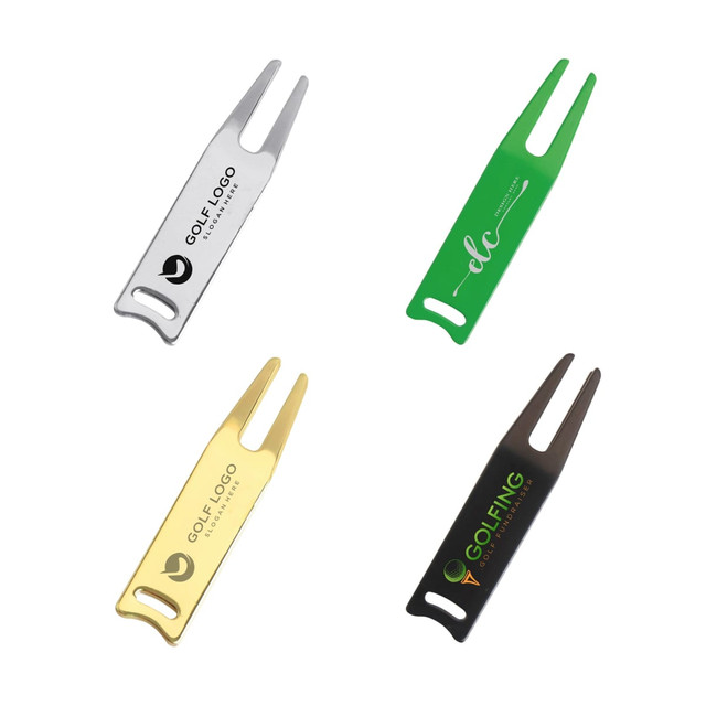 A set of four golf divot tools in silver, green, gold, and black, each featuring a logo.