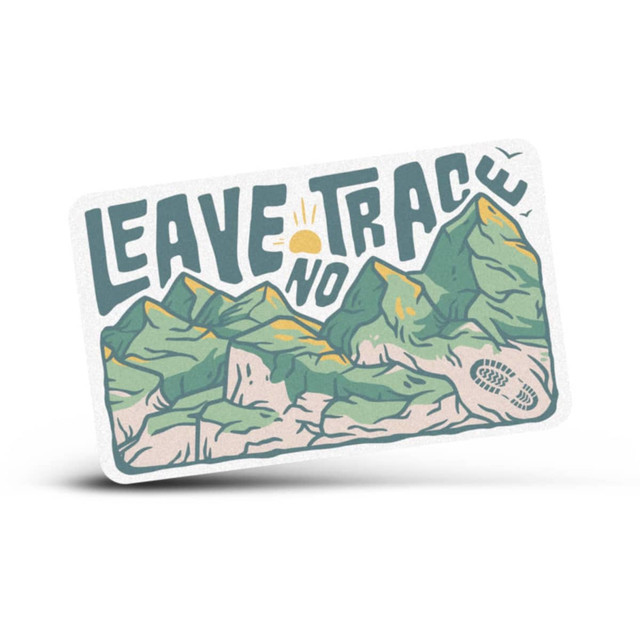 A rectangular sticker featuring green mountains and the phrase "Leave No Trace" in bold lettering.