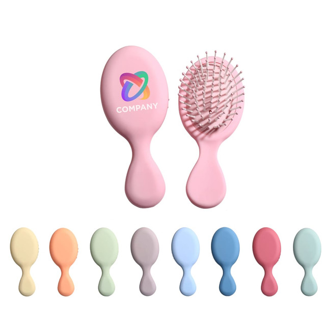 A pink mini paddle brush with a logo, accompanied by pastel-coloured brushes in various shades.