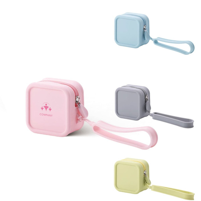 A square silicone coin pouch in pink, light blue, grey, and green, featuring a zipper and a loop for carrying.