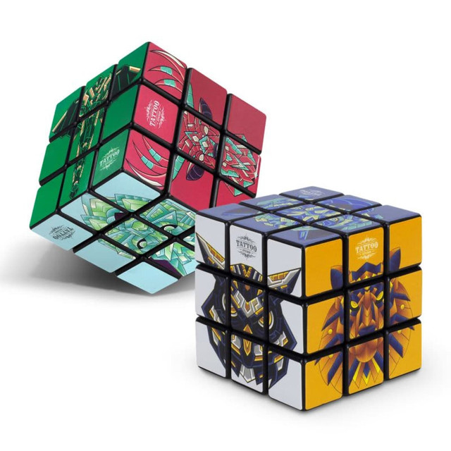 A colourful puzzle cube featuring various intricate designs in green, red, blue, and yellow, with a logo present.