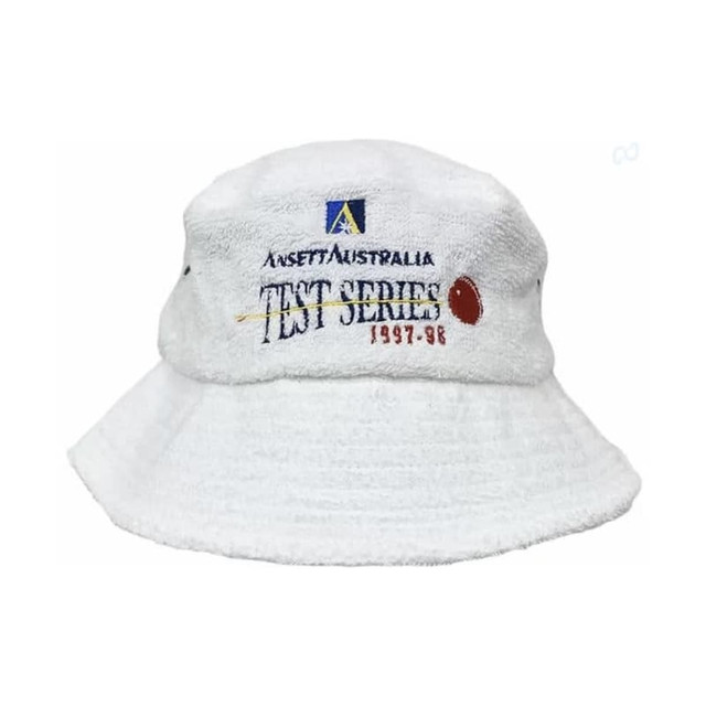 A white terry towelling bucket hat featuring a logo and text. The fabric has a soft, textured appearance.