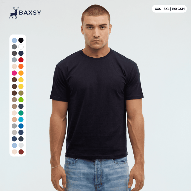 A model wears a navy blue Essential/Surf Tee, featuring a range of colour swatches on the side and a logo at the top.