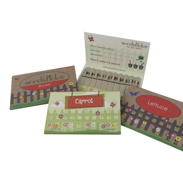Three seed packets for Rocket, Carrot, and Lettuce, featuring colourful, garden-themed designs and a logo.