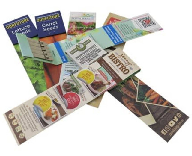 Five stick bookmarks featuring various colourful designs, including vegetable seeds and dining themes, laid out in a fan shape.