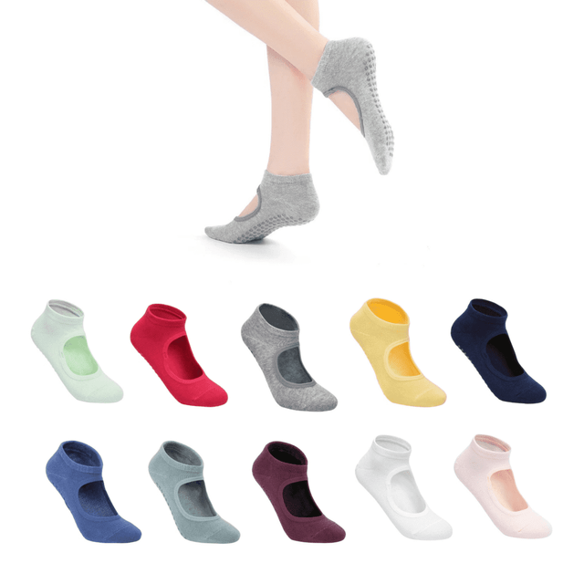 A collection of open-top yoga socks in various colours including grey, pink, navy, and green, with a textured sole.