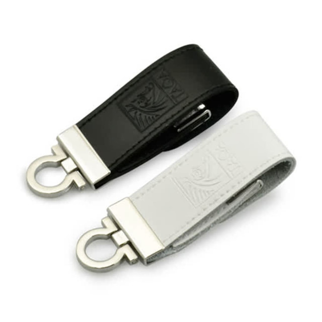 A black and a white seal leather USB flash drive with metal clips, featuring embossed designs.