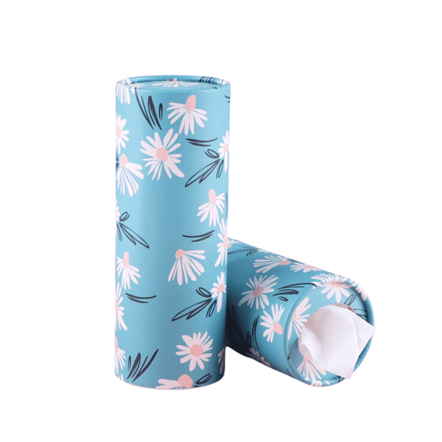 A turquoise car cup tissue holder with a floral design featuring pink daisies. It has a round shape and a logo.