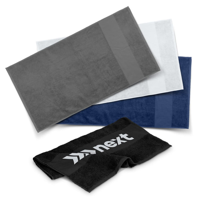 A set of three gym towels in grey, white, and navy, with a towel featuring a logo on the front.