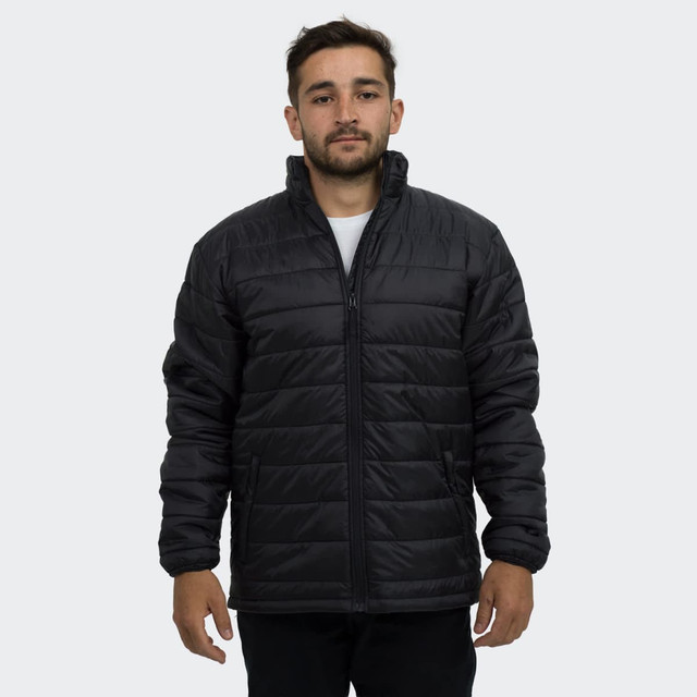 A man wearing a black puffer jacket with a zip and stand-up collar, featuring a logo on the sleeve.