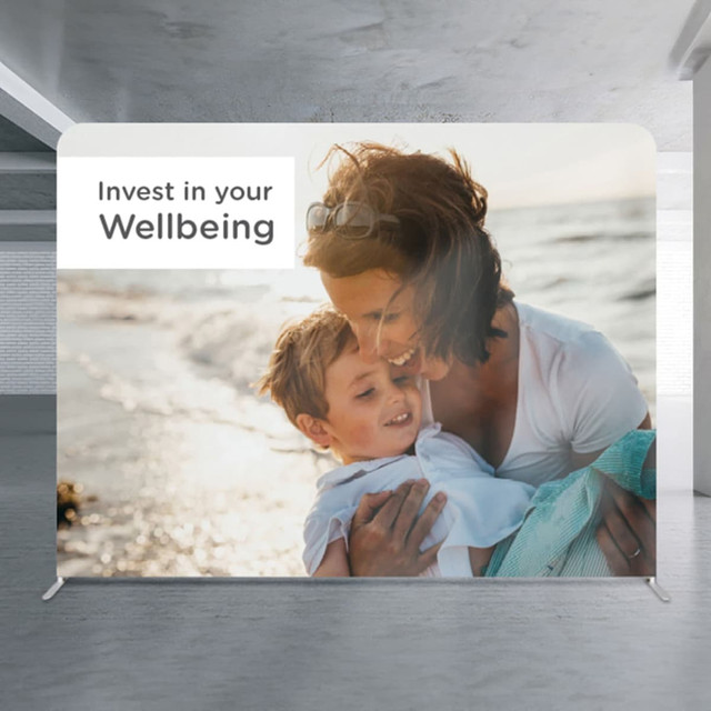 A large media wall featuring a parent and child by the beach, with a light background and a logo.