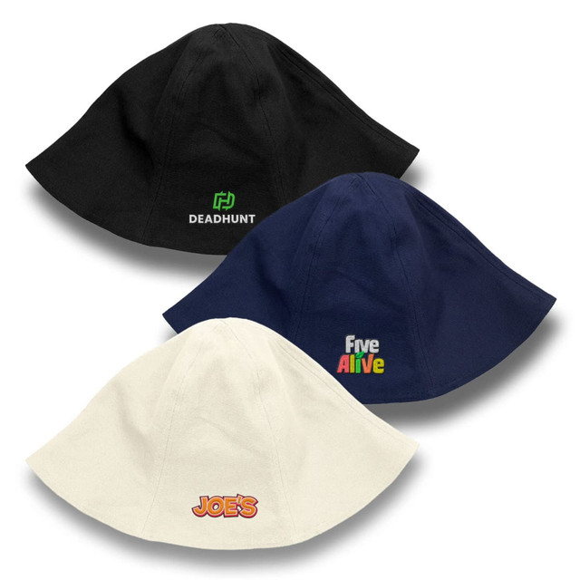 Three Byron Bucket Hats are displayed in black, navy, and cream, each featuring distinctive branding.