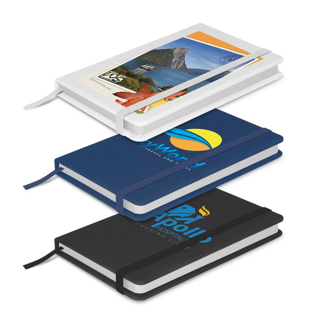 Three notebooks stacked: one white with a colourful cover, one navy blue, and one black, each with a logo and elastic band.