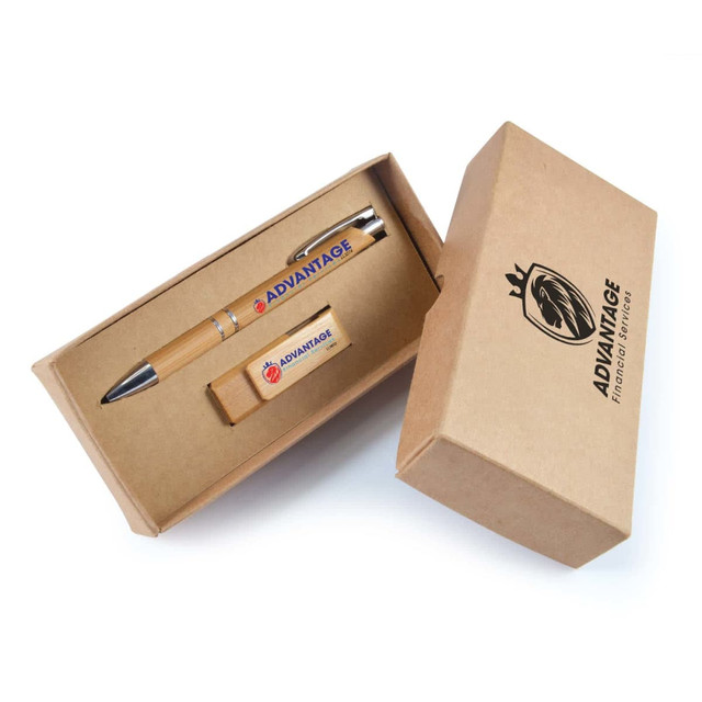 A cardboard gift box containing a silver pen and a wooden USB drive. The pen has a tan barrel, and there is branding on the products.