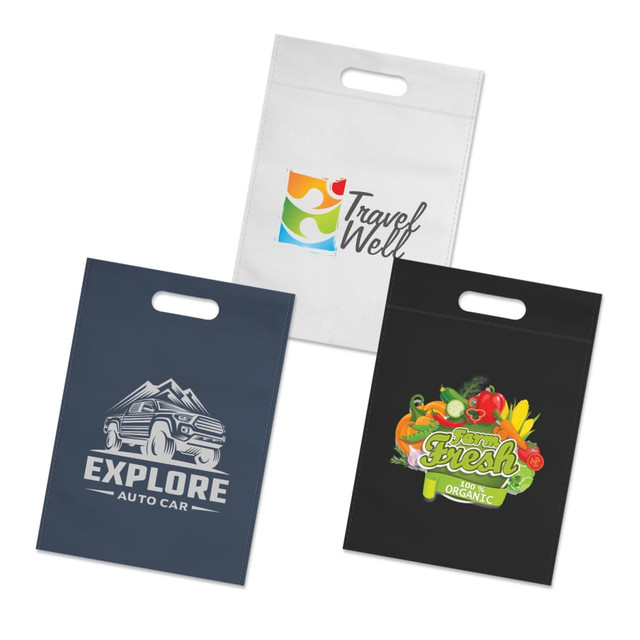 Three tote bags in various colours: a white bag with a logo, a dark blue bag with a car graphic, and a black bag featuring vegetables.