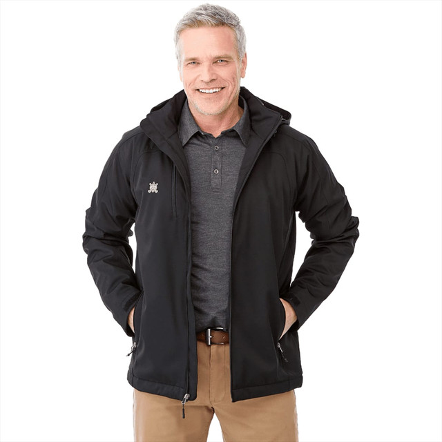 A man wearing a black Bryce Insulated Softshell Jacket with a hood, smiling and standing with hands in pockets.