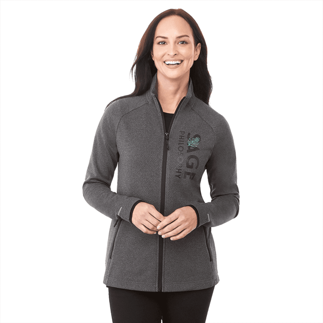 A woman in a grey jacket with a logo, featuring a zip front and high collar.