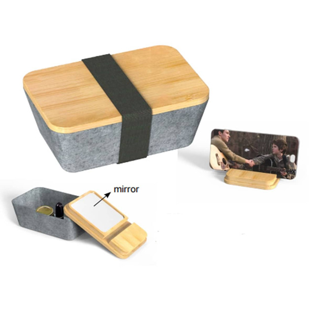 A grey and bamboo beauty case with a mirror and storage, featuring a green strap for closure.