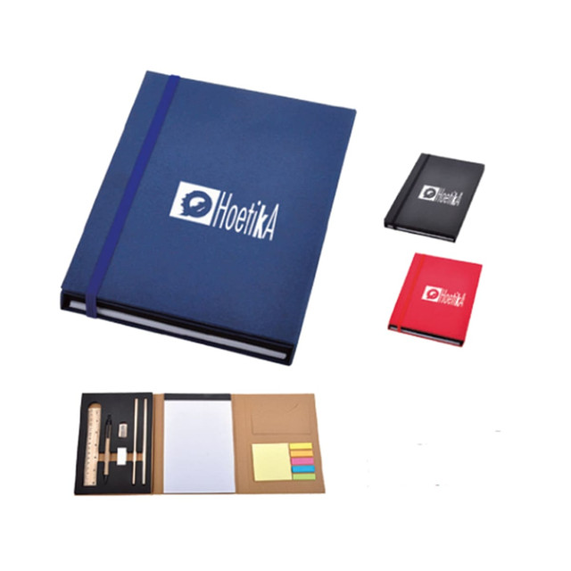 A blue PU notebook with a logo, accompanied by red and black smaller notebooks and stationery items like a ruler and sticky notes.