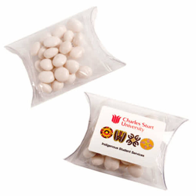 A transparent pillow pack containing white mints, with a logo and graphics on the front.
