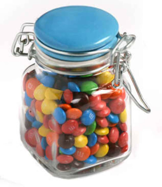 A glass clip lock jar filled with colourful M&Ms, featuring a blue lid and a clear container.