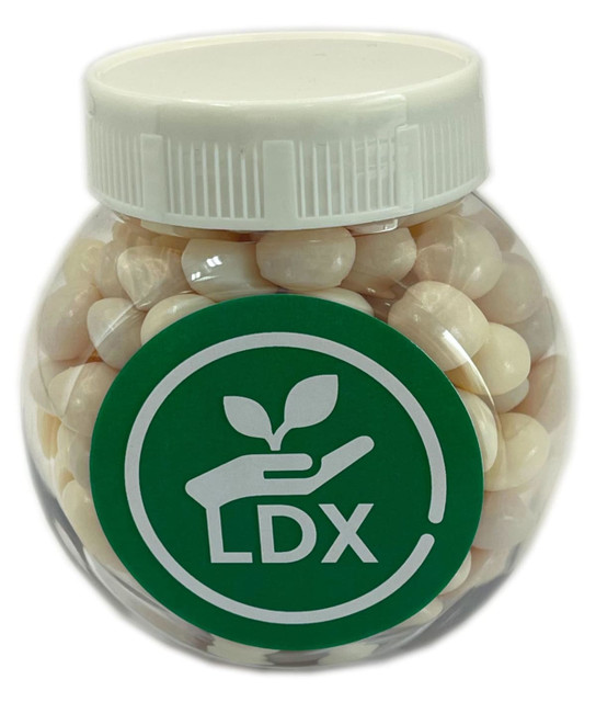 A clear plastic jar filled with white mints, featuring a green logo on the front.