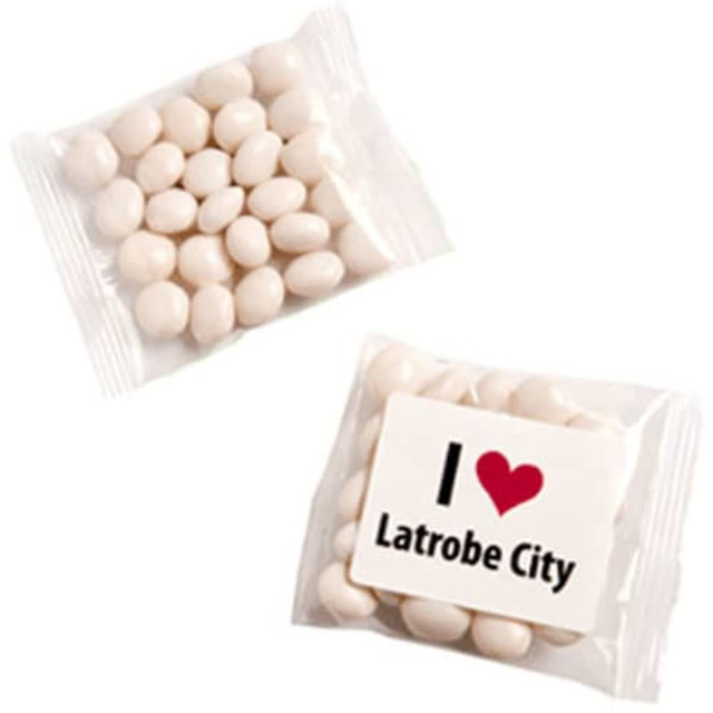 A packet of white mints contains oval-shaped candies. The packaging features a logo and text about Latrobe City.