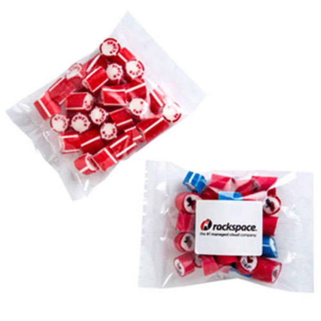 A clear bag containing red and blue rock candy pieces, with a logo on the packaging.