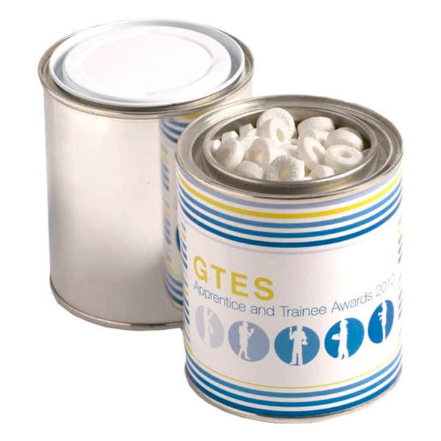 A painted tin filled with white mints, featuring a colourful design and a lid.